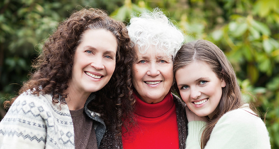 Three generations of women smiling together